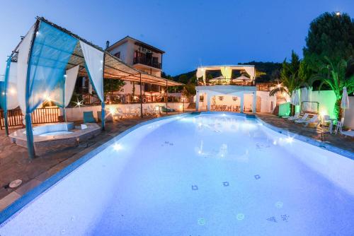 a large swimming pool in front of a house at Seralis Pelion in Afissos