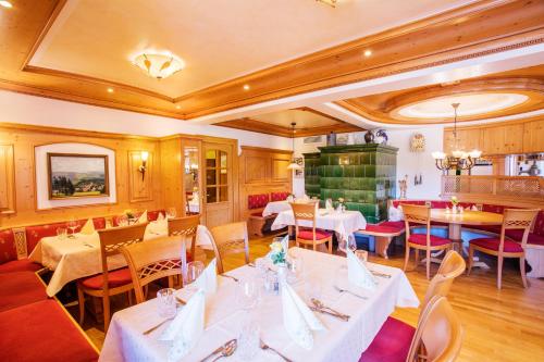a restaurant with tables and chairs in a room at Gasthaus Zum Kreuz in Sankt Märgen