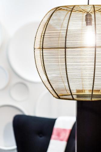 a close up of a lamp with a black chair at C3- Hotel Art De Vivre in Quebec City