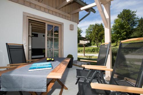a patio with a table and chairs on a porch at Apartments Alp in Bohinj