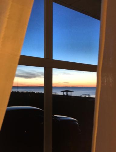 a view of the ocean from a window at Chalet 44 in Grand Barachois