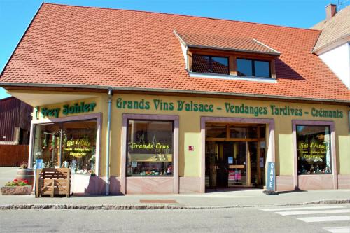 a store front of a building with a lot of windows at La Halte des Vignes - Route des vins d'Alsace in Scherwiller