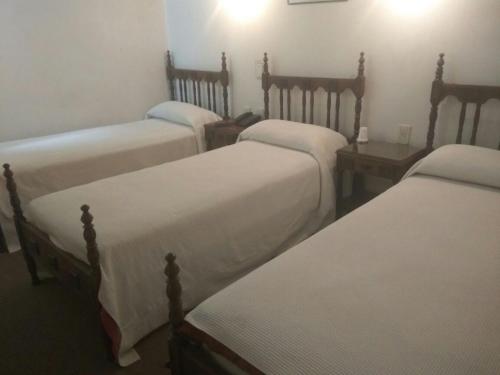 Una cama o camas en una habitación de EMPERATRIZ Hotel Familiar