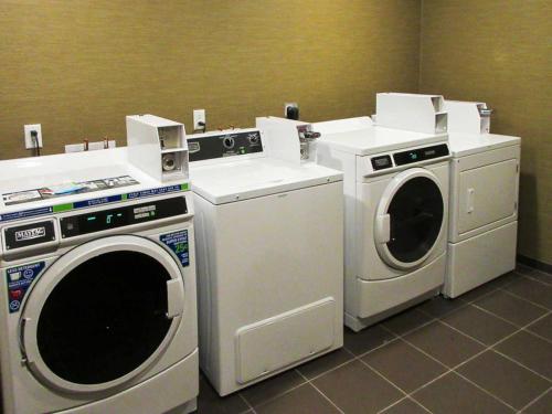 two washing machines and a washer in a room at Sleep Inn & Suites West-Near Medical Center in Rochester