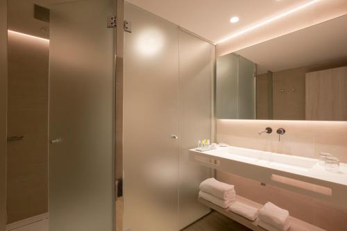 a bathroom with a shower and a sink and a mirror at Canyamel Park Hotel & Spa - 4* Sup - Adults only (+16) in Canyamel