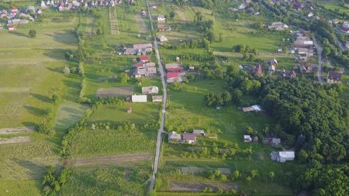 an aerial view of a village with houses and trees at "Plai cu Peri" in Săpînţa