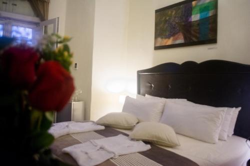 a bedroom with a bed with white sheets and pillows at Casa Falleri Boutique Hotel in Lima
