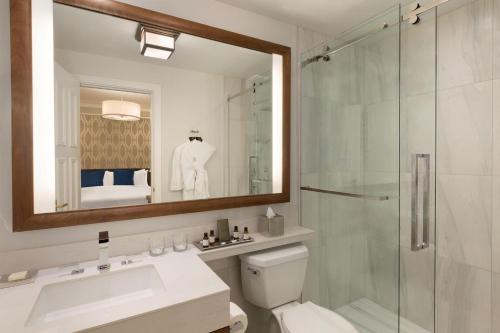 a bathroom with a shower and a toilet and a sink at Fairmont Empress Hotel in Victoria