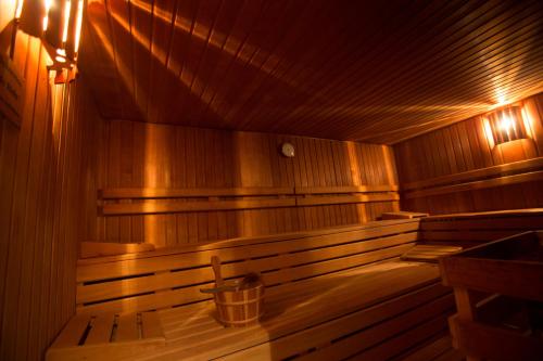 an empty wooden sauna with a bucket in it at Hotel Heiligenstein in Baden-Baden