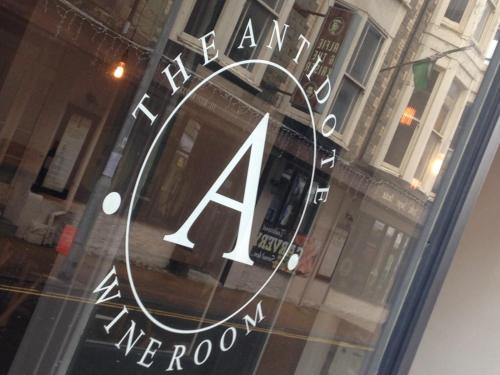 a window of a store with a sign on it at The Antidote in Ilfracombe