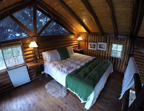 a bedroom with a bed in a wooden cabin at Cabanas del Bajo Hondo in San Pedro