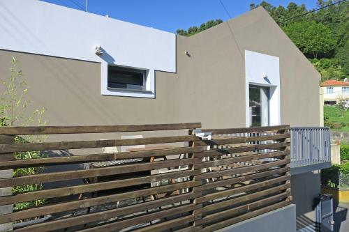 a wooden fence on the side of a house at Furnas Valley in Furnas