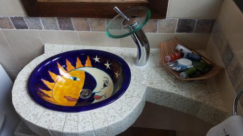 a blue bowl on a counter in a bathroom at La Capilla Hotel Boutique in Valle de Bravo