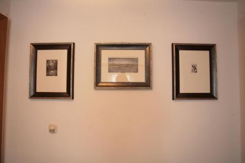 four framed pictures on a wall on a wall at Appartements Haus JÖRG in Serfaus