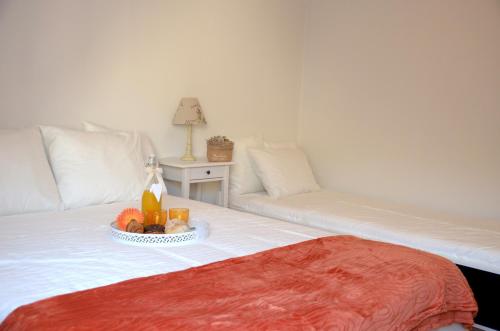 a bed with a white blanket on top of it at Porto Smart Apartments- airport in Perafita