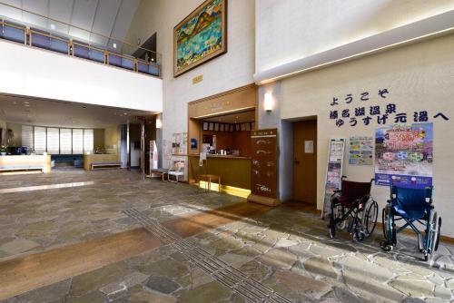 an empty lobby of a building with a wheelchair in the center at Harunako Onsen Yusuge in Takasaki