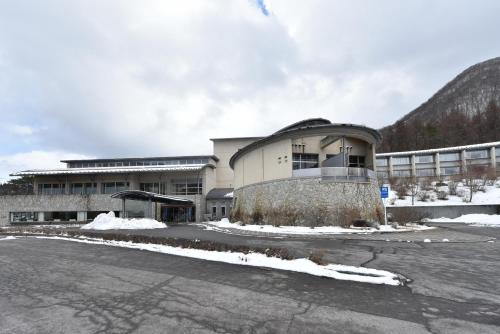 a building with a lot of snow in front of it at Harunako Onsen Yusuge in Takasaki
