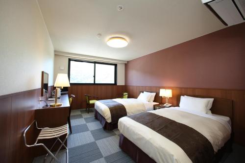 Postel nebo postele na pokoji v ubytování Nezame Hotel