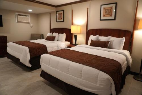 a hotel room with two beds in a room at Beachside Resort in Wildwood