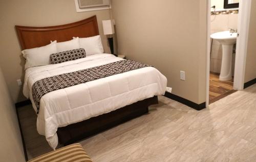 a bedroom with a large bed and a sink at Beachside Resort in Wildwood