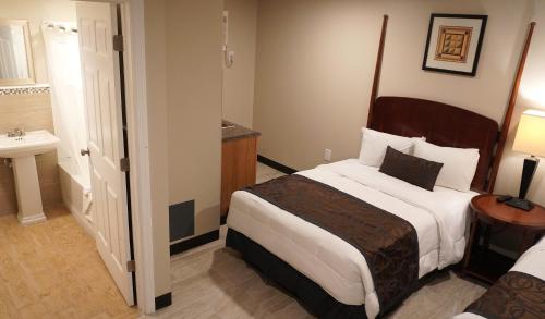 a hotel room with a bed and a sink at Beachside Resort in Wildwood