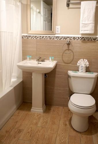 a bathroom with a toilet and a sink at Beachside Resort in Wildwood
