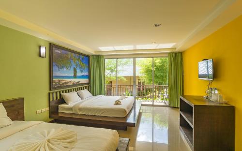 a hotel room with two beds and a window at Krabi Home Town Boutique in Krabi town