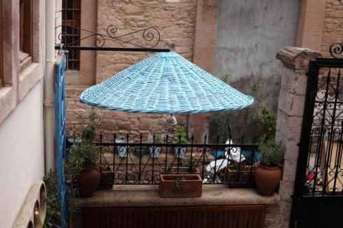 
a table with an umbrella on top of it at Kidalyo Hotel - Special Category in Ayvalık
