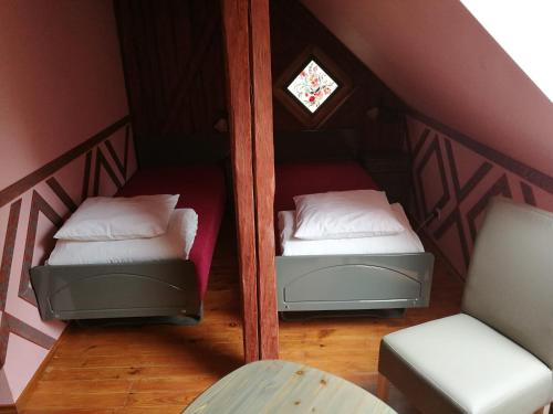 a room with two beds in a attic at Bebru pirts in Vecbebri