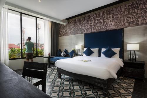 Ένα ή περισσότερα κρεβάτια σε δωμάτιο στο Monthara Angkor Residence