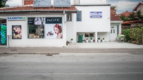 a white building with posters on the side of it at Vila Magdalena in Gevgelija