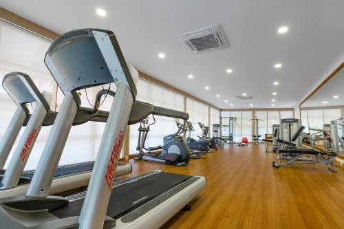 a gym with several treadmills and elliptical machines at Kudafushi Resort & Spa in Raa Atoll