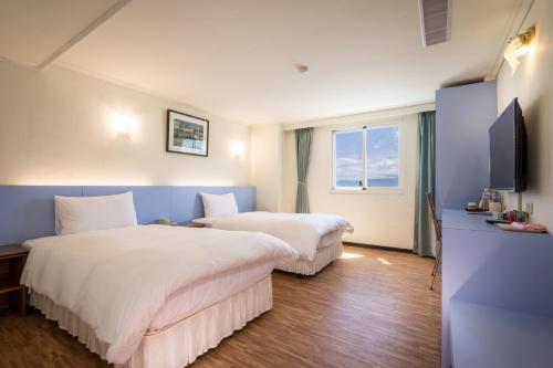 Postel nebo postele na pokoji v ubytování Apple Hotel