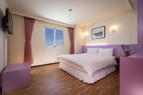 Postel nebo postele na pokoji v ubytování Apple Hotel