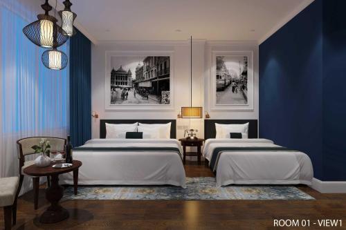 two beds in a room with blue walls at Hanoi Chic Boutique Hotel in Hanoi