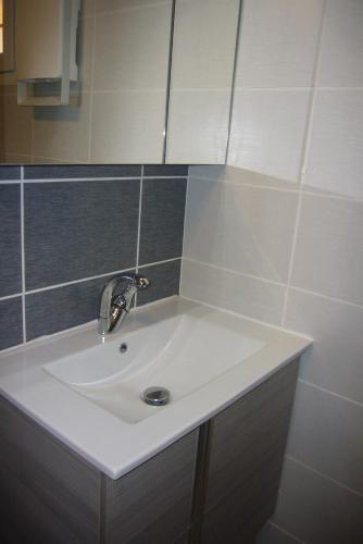 La salle de bains est pourvue d'un lavabo et d'un robinet. dans l'établissement Le Petit Mas du Vigné, à Saint-Pargoire