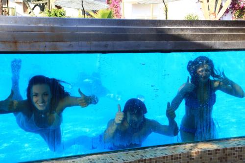 a group of people swimming in the water at Parkim Ayaz Hotel in Gümbet