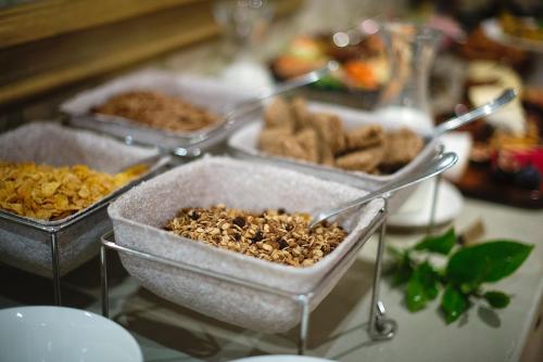 a table with four trays of food on it at Last Word Constantia in Cape Town