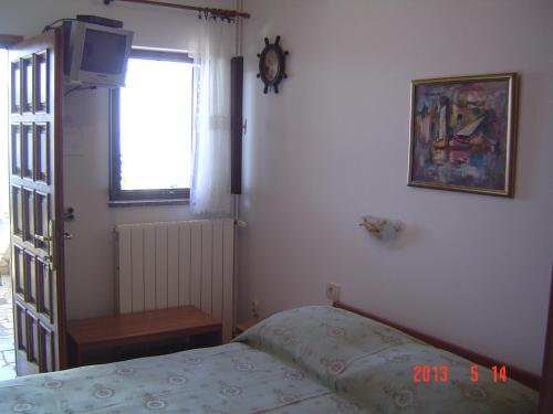莫什尼卡德拉加的住宿－Room Rubinić，一间卧室设有一张床、一个窗口和一个时钟