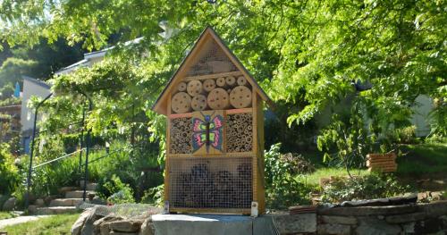 a small bird house sitting in a garden at La Cadanise, Suite Étoilée in Saint-Éloy-les-Mines