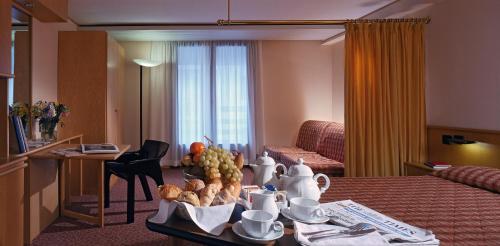 a hotel room with a table with food on it at Hotel Les Jumeaux Courmayeur in Courmayeur