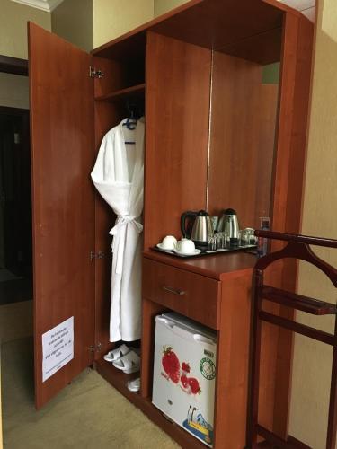 a room with a cupboard and a kitchen at Royal Hotel in Baku