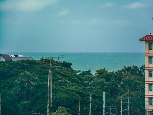 a view of the ocean and a tall building at Baan Yokmhanee in Hua Hin