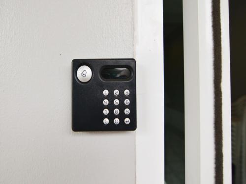 a black remote control on a white door at Baan Yokmhanee in Hua Hin