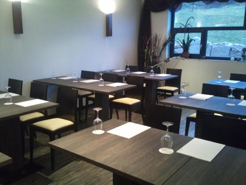 a restaurant with tables and chairs with wine glasses on them at Reit- und Sporthotel Eibenstock in Eibenstock