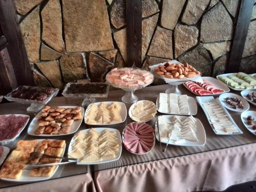 a table topped with lots of different types of food at Royal Hotel in Baku