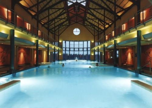 a large swimming pool with people swimming in it at Reit- und Sporthotel Eibenstock in Eibenstock