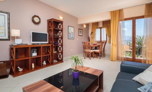 a living room with a couch and a table at Apartments Judita in Supetar