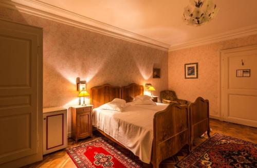a bedroom with a large bed in a room at Swiss Historic Hotel Masson in Montreux