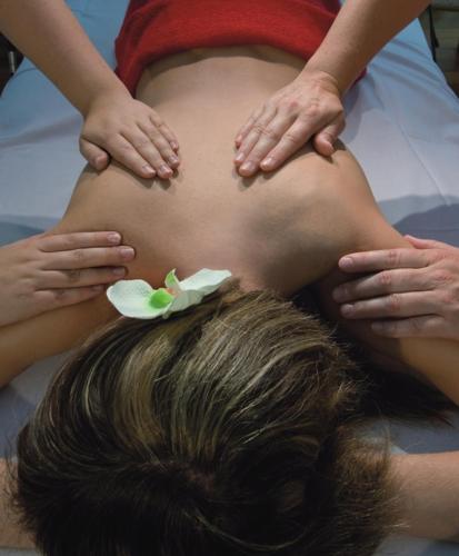 a pregnant woman with a flower on her stomach at Reit- und Sporthotel Eibenstock in Eibenstock